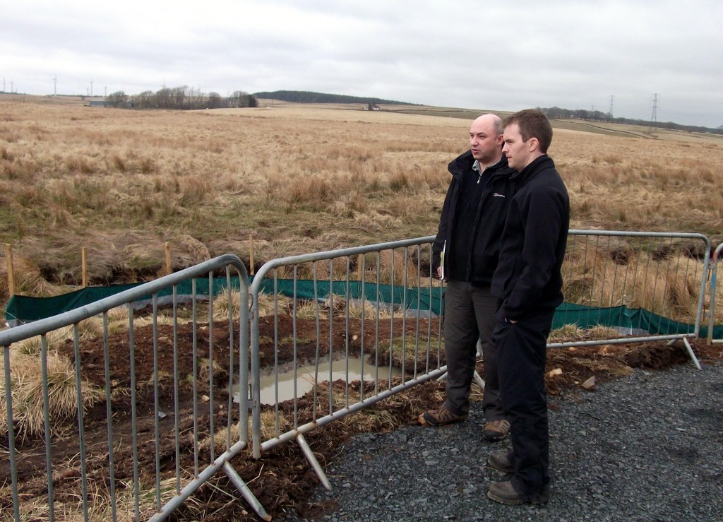Pic3. Roddy talks to Richard McMullan of Eco-Fish Consultants about the groundworks at the West Browncastle Wind Farm site (note: the small sediment lagoon + silt fencing that has been engineered at the base of the temporary site compound)